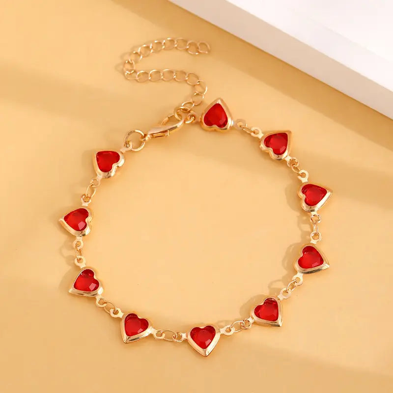 Elegante gouden armband met subtiele garnet steentjes