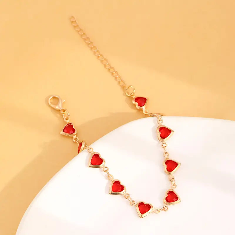 Elegante gouden armband met subtiele garnet steentjes